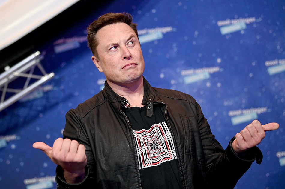 SpaceX owner and Tesla CEO Elon Musk gestures as he arrives on the red carpet for the Axel Springer Awards ceremony, in Berlin, on December 1, 2020. Britta Pedersen / POOL / AFP