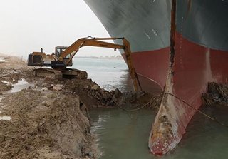 Lone backhoe tries to dislodge giant cargo ship grounded on the Suez Canal
