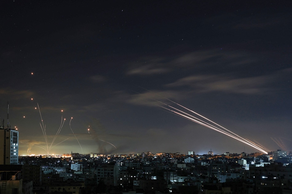Israel's Iron Dome missile defense system (left) intercepts rockets (right) fired by the Hamas movement from Gaza city towards Israel. Mohammed Abed, AFP/file