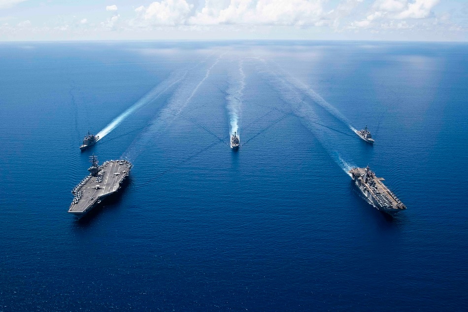 This US Navy photo obtained October 7, 2019 shows the aircraft carrier USS Ronald Reagan underway in formation while conducting security and stability operations in the US 7th Fleet area of operations on October 6, 2019 in the South China Sea. US 7th Fleet is the largest numbered fleet in the world, and the US Navy has operated in the Indo-Pacific region for more than 70 years, providing credible, ready forces to help preserve peace and prevent conflict. Erwin Jacob V. Miciano, Navy Office of Information, AFP/file