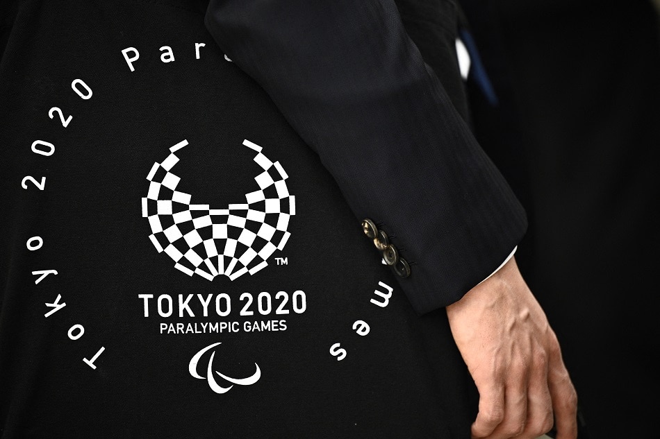 A government official carries a bag with the logo of the Tokyo 2020 Paralympic Games during a meeting at the Tokyo metropolitan government building 