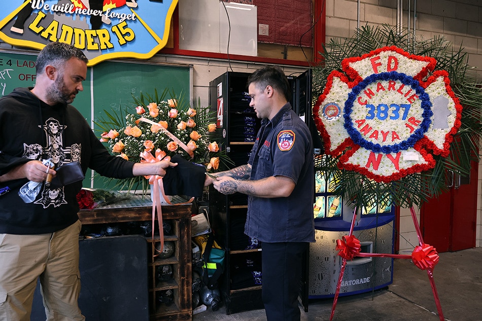 The FDNY Ladder 15 and Engine 6 station house is decorated with flowers and memorial arrangements honoring those who died 20 years ago in the September 11, 2001 terrorist attack on September 10, 2021 in New York City. The FDNY lost 343 firefighters that day, including 14 from this station house on South Street in Lower Manhattan. Chip Somodevilla, Getty Images via AFP 