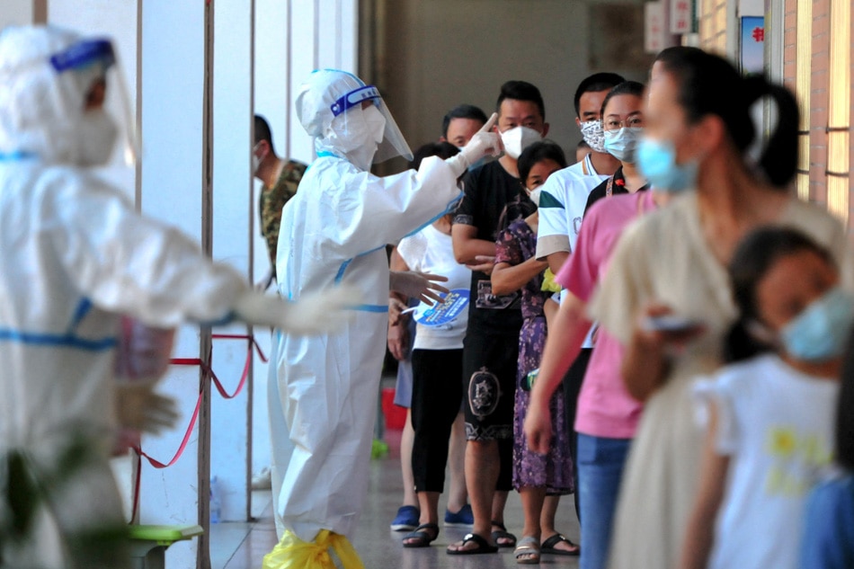 Residents queue to undergo nucleic acid tests for the Covid-19 coronavirus in Xianyou County, Putian city, in China's eastern Fujian province on Monday. CNS, AFP