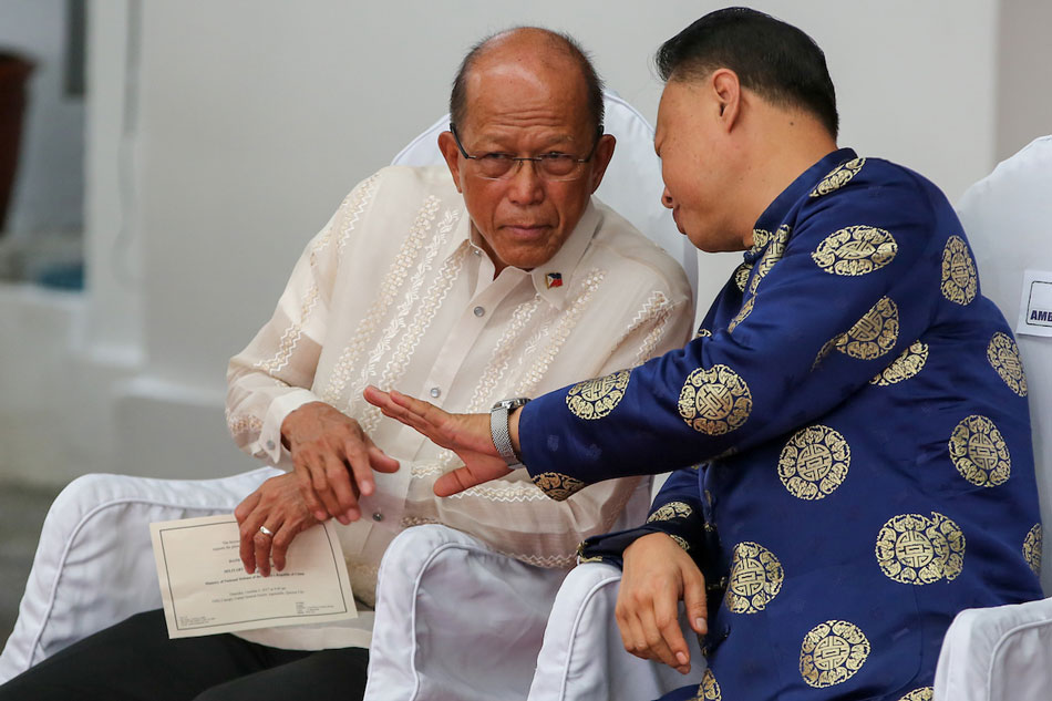 Defense Secretary Delfin Lorenzana and then-Chinese Ambassador to the Philippines Zhao Jianhua discuss during turnover ceremonies of China-made weapons to the Philippines at the Armed Forces of the Philippines (AFP) in Quezon City, October 5, 2017. Jonathan Cellona, ABS-CBN News/File