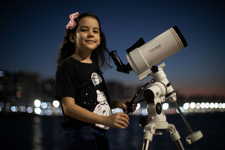  Brazilian 8-year-old astronomer Nicole Oliveira poses for a picture with her telescope in Fortaleza, Brazil. Jarbas Oliveira, AFP