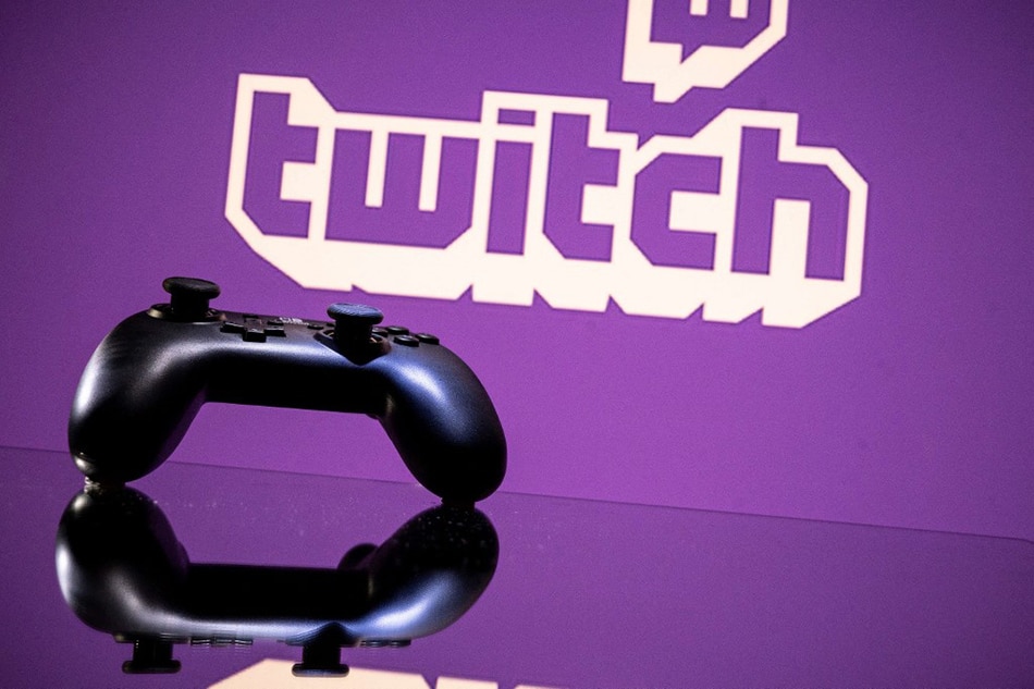 In this file photo taken on June 14, 2021, gamepad is pictured as a screen displays the online Twitch platform in Toulouse, southwestern France. Amazon's popular live video streaming platform Twitch said on October 6, 2021, hackers had broken into its network after reports of exposed confidential company data surfaced online. AFP