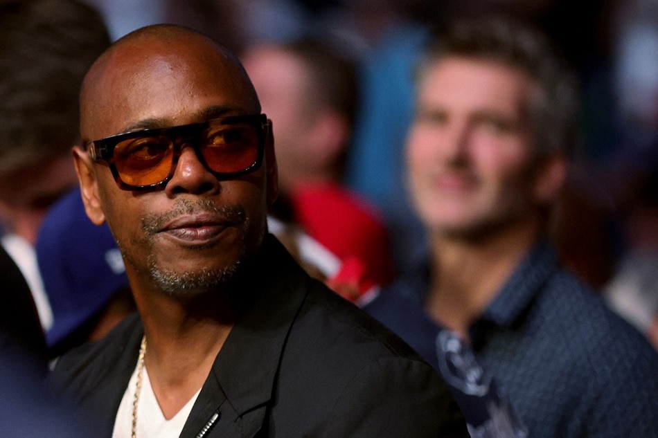 In this file photo taken on July 10, 2021 Dave Chappelle looks on during UFC 264: Poirier v McGregor 3 at T-Mobile Arena in Las Vegas, Nevada. Stacy Revere, Getty Images North America/AFP