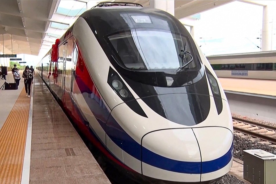 This frame grab from Lao National TV video footage taken on October 16, 2021 via AFPTV shows the Lane Xang bullet train at the Vientiane Railway Station in Vientiane. A new 6 billion USD Chinese-built railway line opens in Laos on December 3, bringing hopes of an economic boost to the reclusive nation, but experts are questioning the benefits of a project that has seen thousands of farmers evicted from their land. STR / LAO NATIONAL TV / AFPTV / AFP