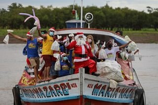 In Brazil's sweltering Amazon, Santa swaps his sled for boat