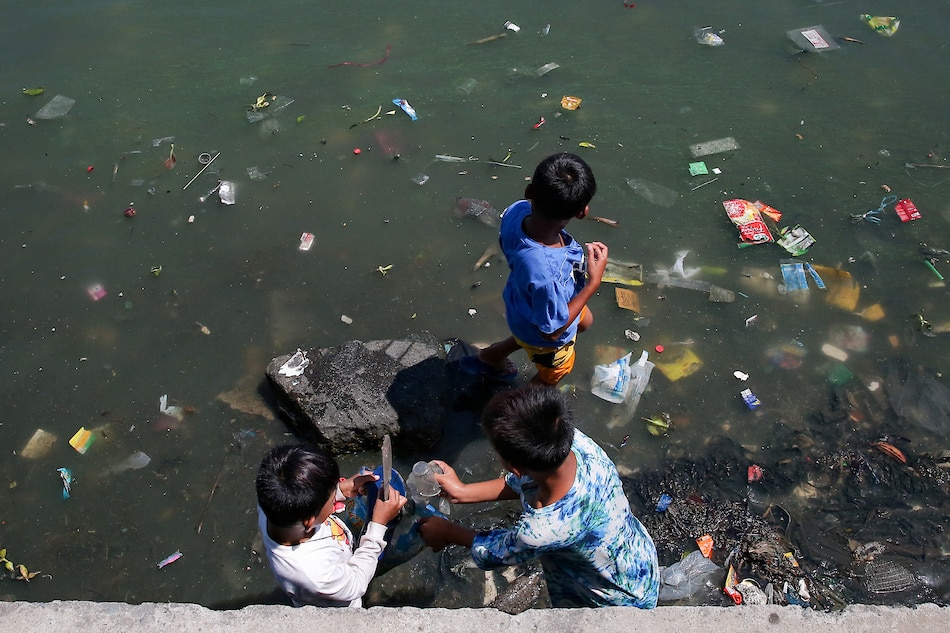 Children gather garbage near the mouth of Pasig river that connects it to Manila Bay in Baseco Compound in Tondo, Manila on World Environment Day, June 5, 2021. George Calvelo, ABS-CBN News