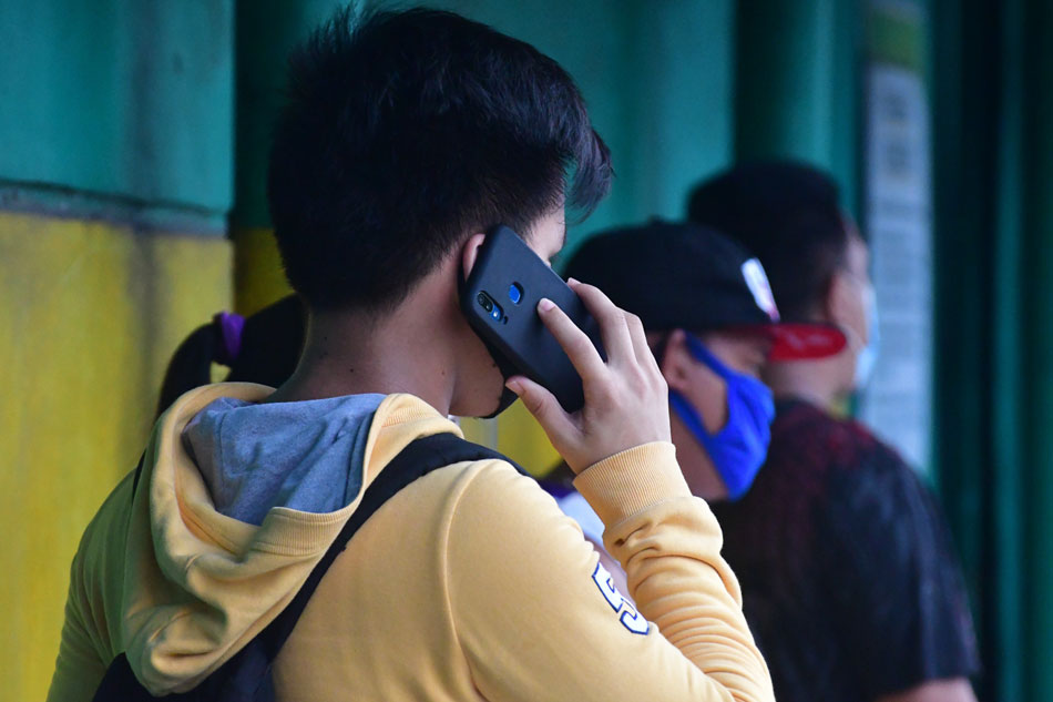 Citizens use their mobile phones in Quezon City amid the modified enhanced community quarantine on August 16, 2020. Mark Demayo, ABS-CBN News/File