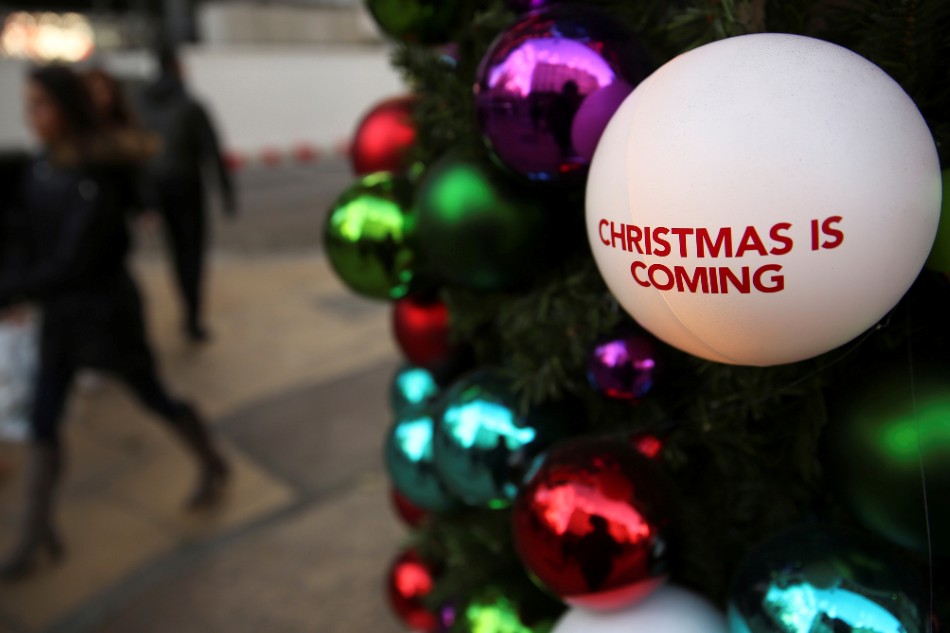 Shoppers walk past Christmas decorations in London, Britain December 3, 2016. Neil Hall, Reuters/File Photo