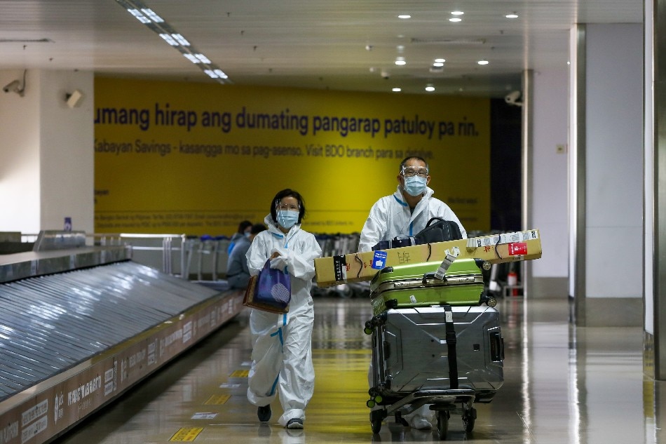 Travellers wearing personal protective equipment as a precuation against COVID-19 arrive at the Ninoy Aquino International Airport (NAIA) in Parańaque City on March 17, 2021. Jonathan Cellona, ABS-CBN News/File