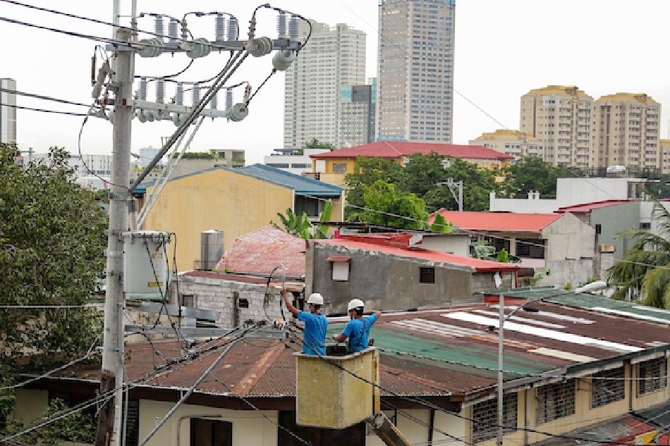  Linemen work on electrical posts on a street in Mandaluyong on September 15, 2021. George Calvelo, ABS-CBN News/File