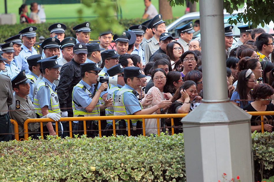 Police officers remove fans standing outside the opening ceremony of the 17th Shanghai International Film Festival, June 14, 2014. Aly Song, Reuters/file