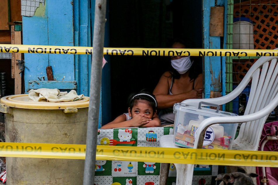 A child covers her face as they spend time inside their house in Barangay UP Campus, Quezon City on the first day of the re-implementation of the Enhanced Community Quarantine (ECQ) on August 6, 2021. George Calvelo, ABS-CBN News