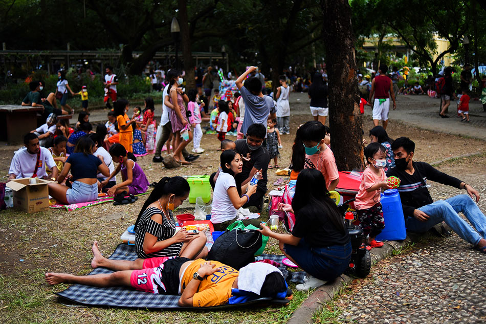 Parents and children relax at a public park rtr