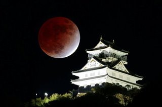 Partial lunar eclipse seen over Gifu Castle