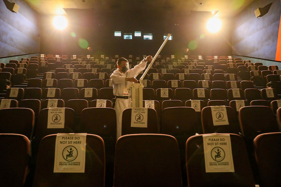 A movie theater at the Gateway Mall in Araneta Center, Quezon City gets disinfected on November 10, 2021. Jonathan Cellona, ABS-CBN News 