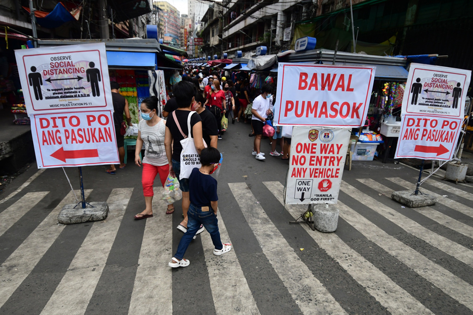 Shoppers go around the Divisoria market in Manila on Sunday, November 14, 2021. 