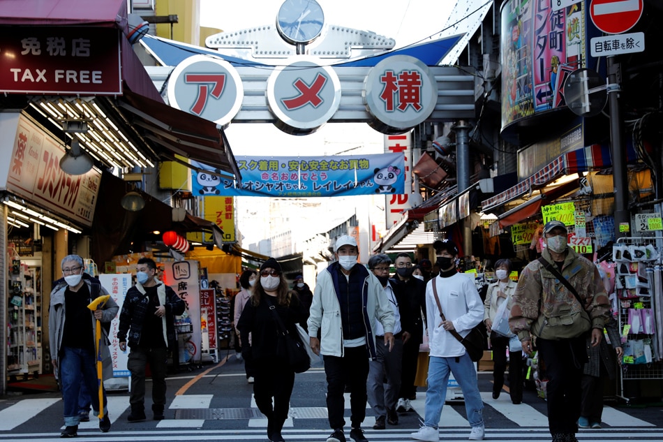 Pedestrians wearing protective masks, amid the COVID-19 outbreak, make their way at the Ameyoko shopping district in Tokyo, Japan, Dec. 1, 2021. Kim Kyung-Hoon, Reuters