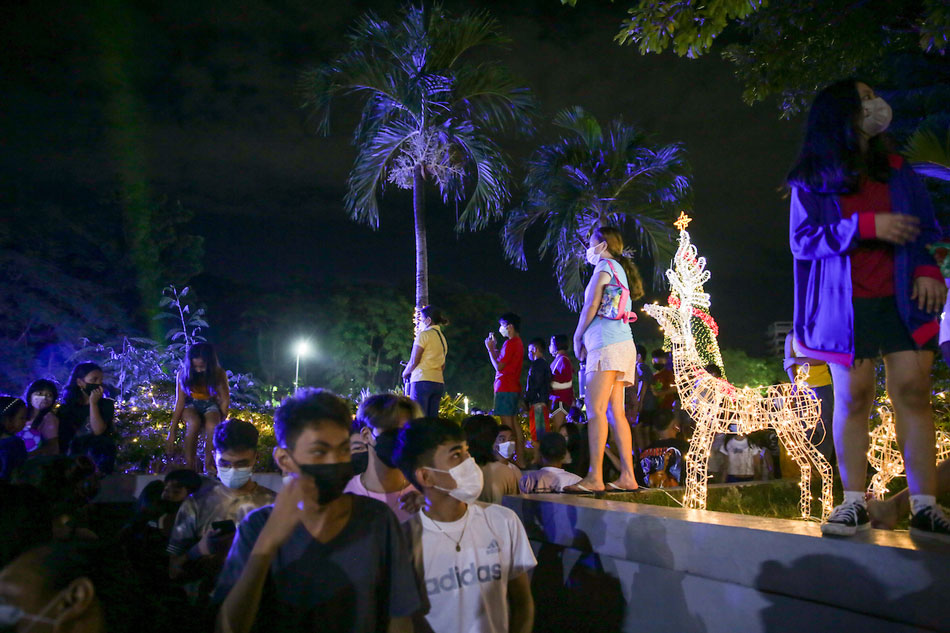 People attend the Christmas tree lighting at the San Juan City hall grounds on December 3, 2021. George Calvelo, ABS-CBN News