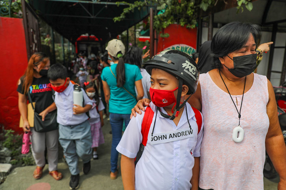 Parents wait for their children after attending the first day of face to face classes at the Ricardo P. Cruz Sr. Elementary School in Taguig City on December 06, 2021. Jonathan Cellona, ABS-CBN News