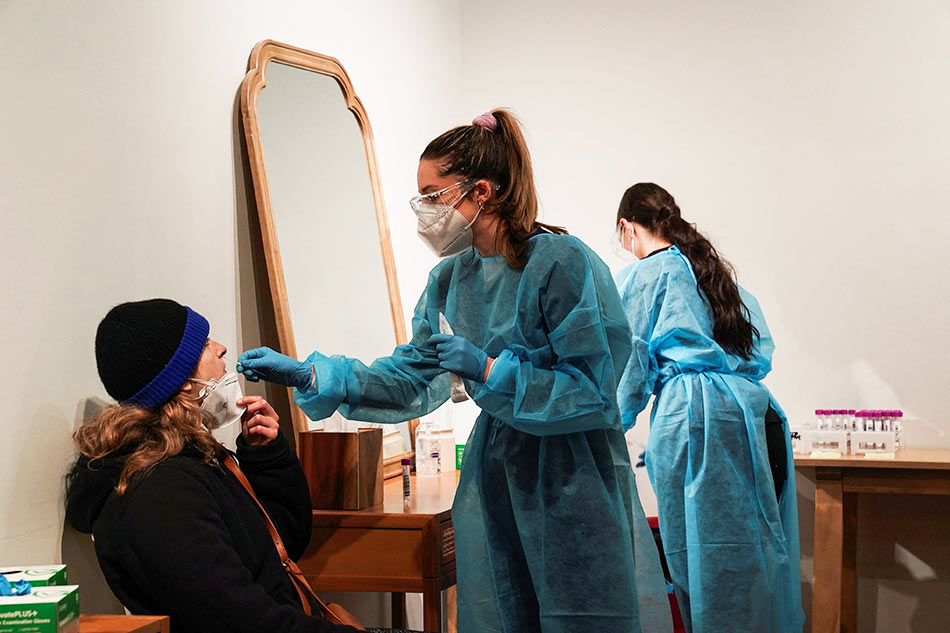 nurse administers a nasal swab test rtr