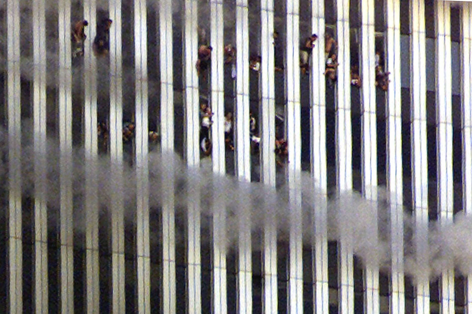 The twin towers of the World Trade Center billow smoke after hijacked airli...