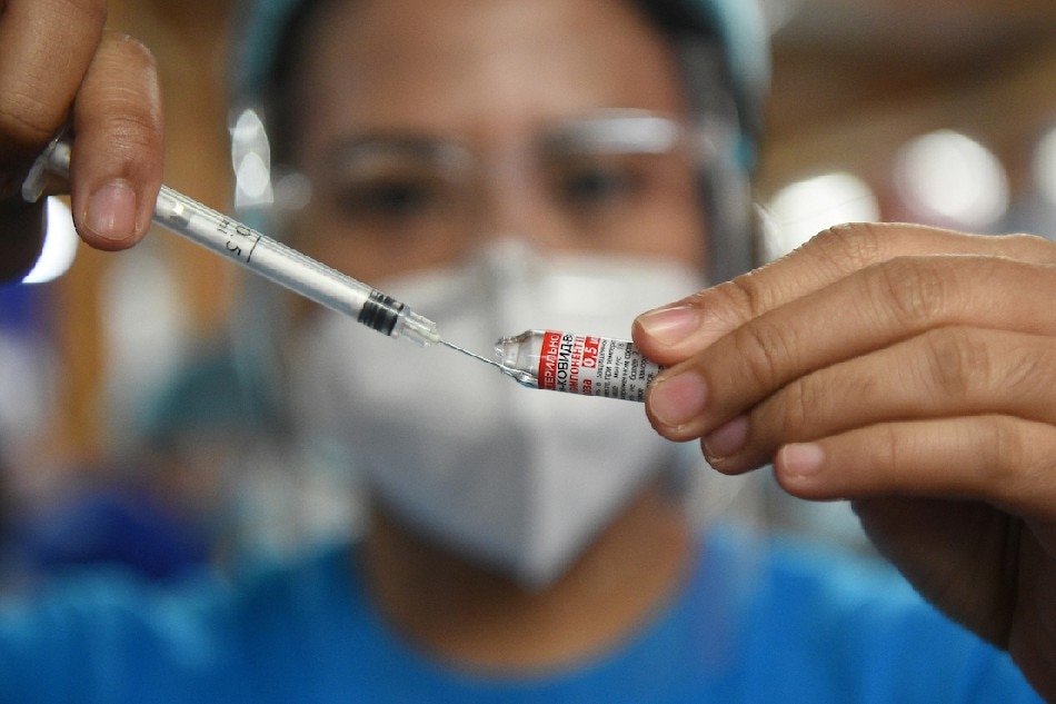 A health worker prepares a dose of Gamaleya National Center of Epidemiology and Microbiology's Sputnik V Covid-19 vaccine during a vaccination for residents in Mandaluyong City on July 15, 2021. Ted Aljibe, AFP