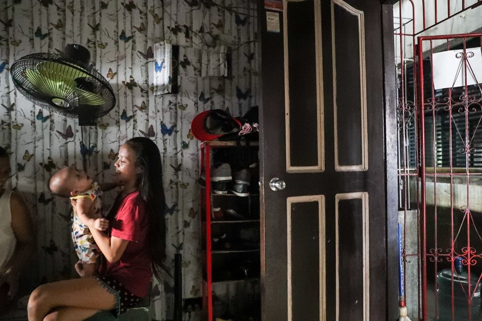 'Jessy' 16, cares for her infant baby inside their home in a permanent housing tenement in Bgy. Smokey Mountain, Tondo Manila, May 9, 2018. Jonathan Cellona, ABS-CBN News/File