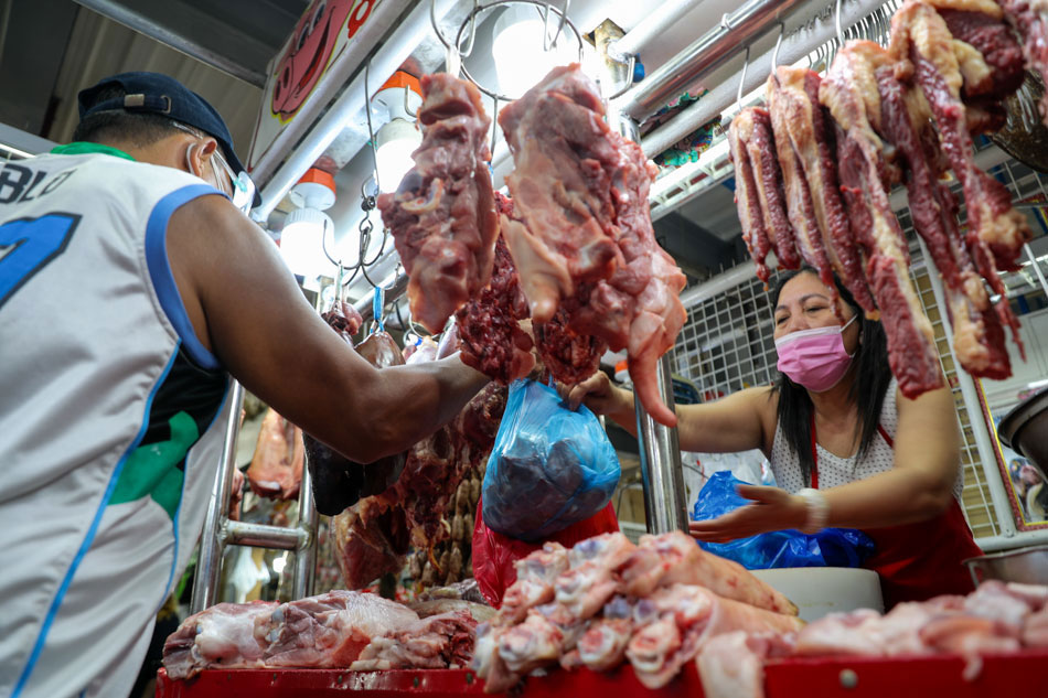 A vendor tends to her stall selling pork and other meat products at the Paco Market in Manila on May 6, 2021. Jonathan Cellona, ABS-CBN News/File
