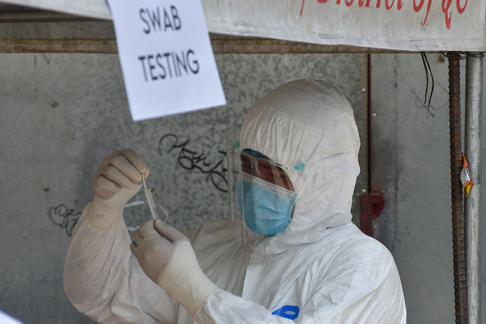 Members of the Quezon City Epidemiology and Disease Surveillance conduct COVID-19 swab testing for residents along Dupax Street in Barangay Old Balara on May 31, 2021. 