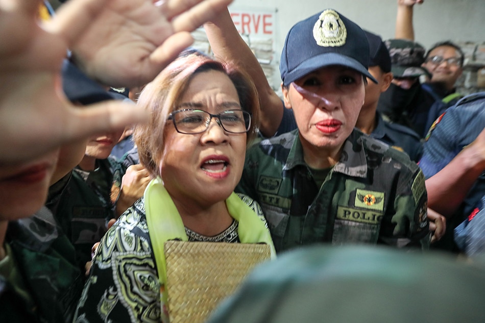 Senator Leila De Lima is escorted by heavy guards as she attends her hearing at the Quezon City Regional Trial Court on Friday, June 22, 2018. The detained senator is seeking reelection for the 2022 polls. Jonathan Cellona, ABS-CBN News