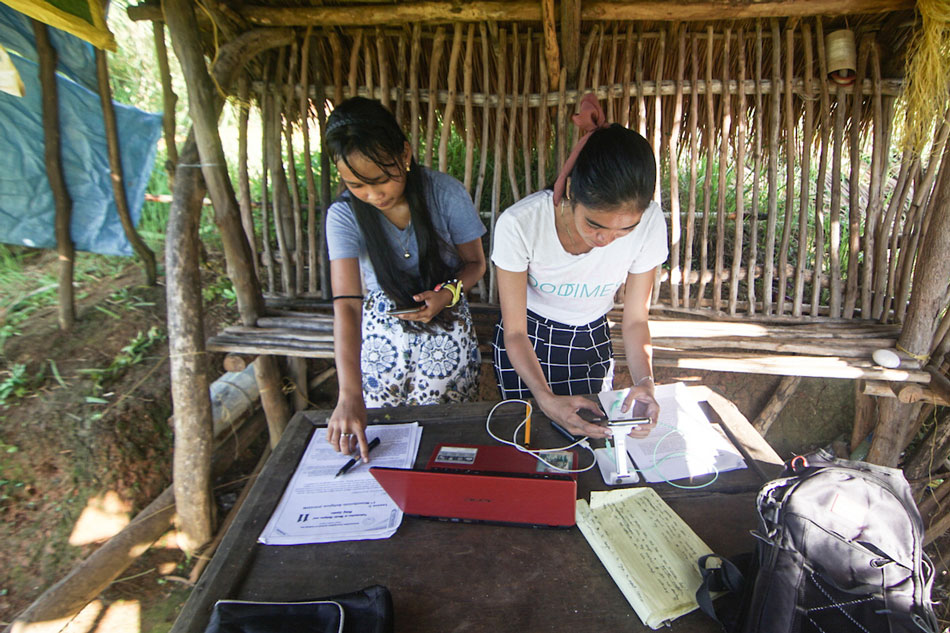 Two students from Suluan Island in Guiuan, Eastern Samar review their notes on May 23, 2021. 