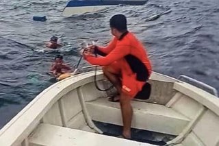 Coast Guard rescues 2 fishermen from capsized boat in Batangas