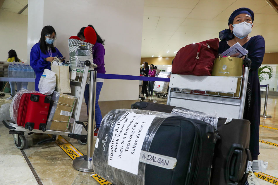 Overseas Filipino workers arrive at the lobby of the Ninoy Aquino International Airport (NAIA) Terminal 1 in Parañaque City, July 1, 2021. Jonathan Cellona, ABS-CBN News/File