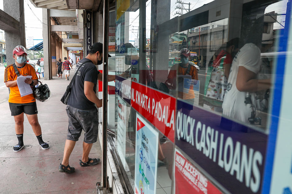 People visit a money changer and remittance business in Marikina City on January 21, 2021. 