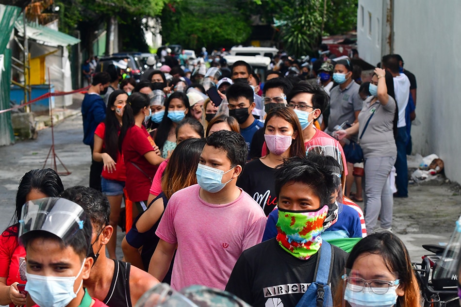 Residents mostly from barangays under District 4 in Quezon City queue for vaccination at Don Alejandro Roces Sr. Science-Technology High School on August 5, 2021, a day before Metro Manila is placed under enhanced community quarantine. Mark Demayo, ABS-CBN News
