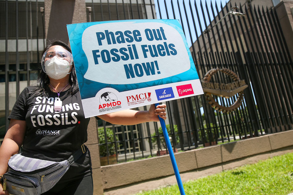 Members of the Asian Peoples Movement on Debt and Development protest in front of the Asian Development Bank in Ortigas Center, Mandaluyong City on June 17, 2021 while the bank is hosting the annual Asia Clean Energy Forum (ACEF 2021).