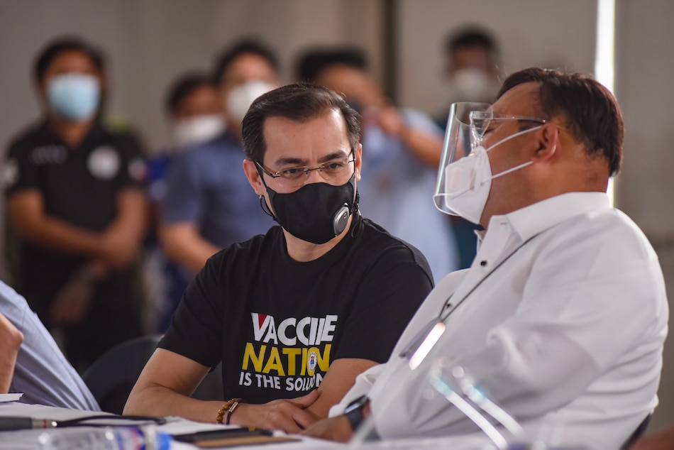 Manila Mayor Isko Moreno speaks to Presidential spokesperson Harry Roque during a ceremonial launch of the vaccination program for seafarers at the Palacio de Maynila in Manila on June 17, 2021. Around 1,200 doses of the US-made vaccine Pfizer from the COVAX facility were allocated by the city government for the vaccination of seafarers. George Calvelo, ABS-CBN News/File 