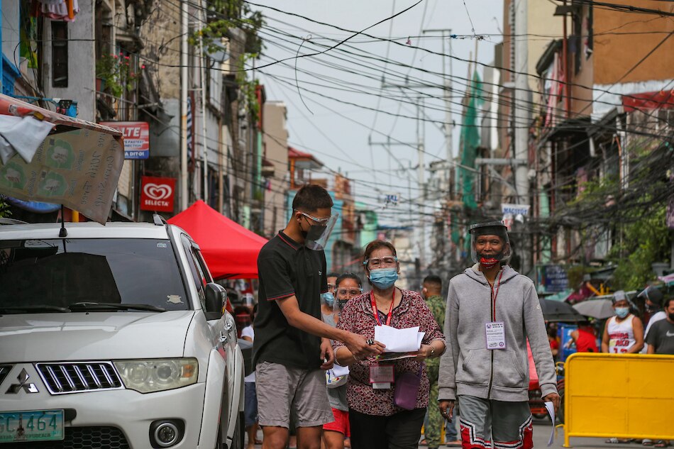Residents return home after claiming their cash assistance for those affected by the COVID-19 pandemic at the Brgy. Maricaban covered court in Pasay City on Aug. 11, 2021 as the capital region remains under enhanced community quarantine. Jonathan Cellona, ABS-CBN News