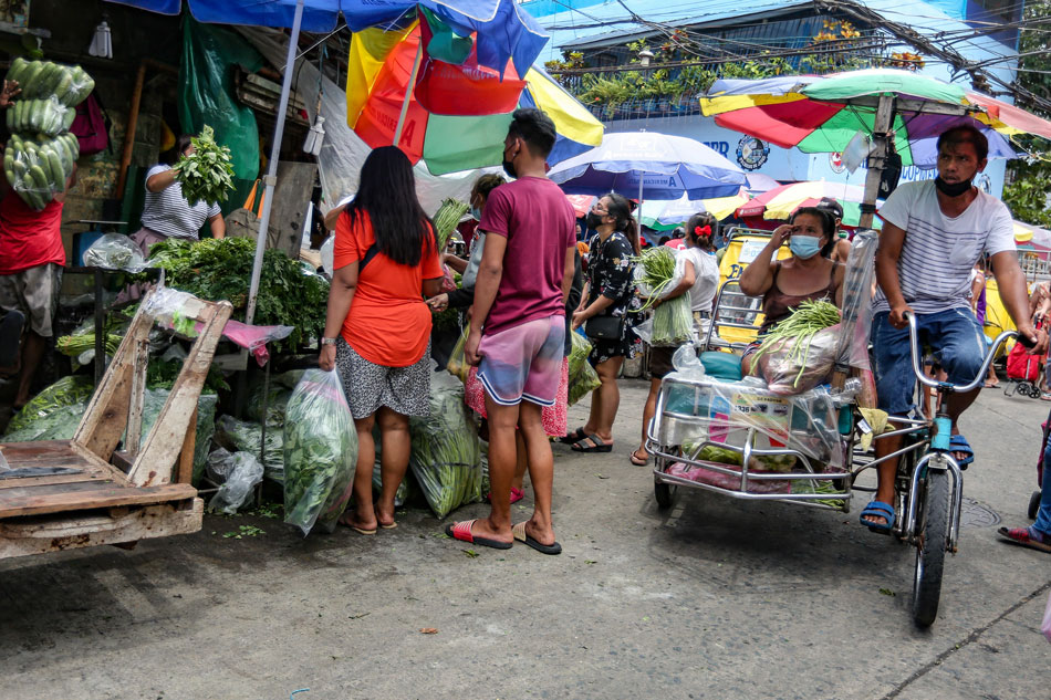 People rush to buy goods at a market in Divisoria, Manila on August 5, 2021.