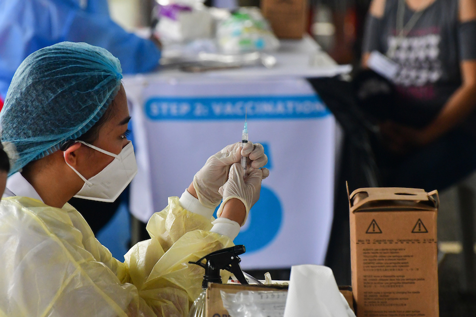 Delivery and transport workers queue to receive a COVID-19 vaccine shot at the Vaccine Express, a drive-thru vaccination initiative under the Office of the Vice President, in a mall parking lot in Quezon City on August 12, 2021. Mark Demayo, ABS-CBN News