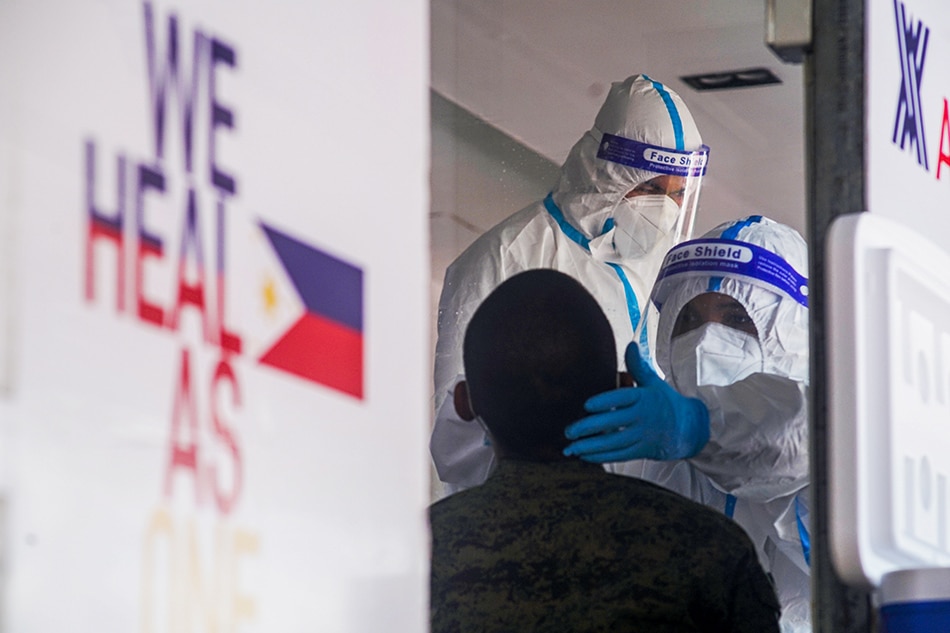 A personnel of the Armed Forces of the Philippines (AFP) undergoes RT-PCR test for COVID-19 at the Ninoy Aquino Stadium Mega Swabbing facility in Malate, Manila on June 6, 2021 More Heramis, ABS-CBN News/File
