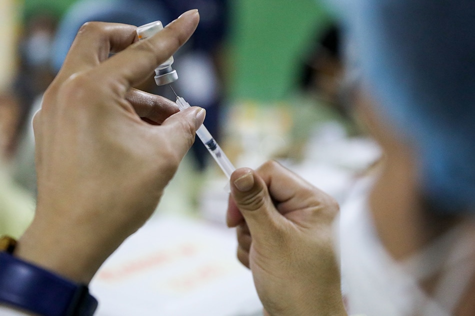Pasig residents are vaccinated against COVID-19 during the Pasig edition of the Office of the Vice President’s Vaccine Express initiative at the Manggahan High School on Aug. 21, 2021. Charlie Villegas, OVP