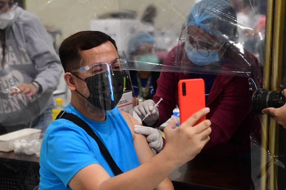 Mandaluyong residents and workers receive their second dose of COVID-19 vaccines at the SM Megamall vaccination site on July 14, 2021. Mark Demayo, ABS-CBN News/File