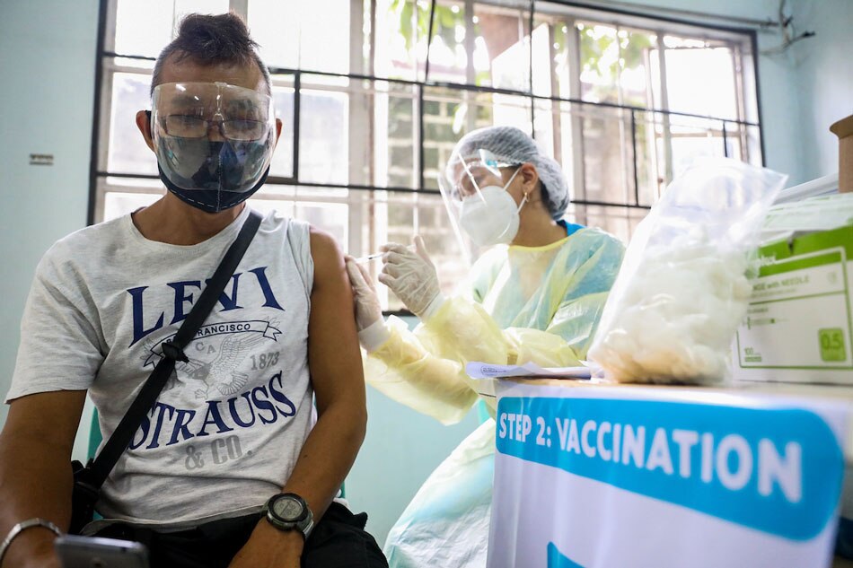  A resident is vaccinated against COVID-19 during the Office of the Vice President’s (OVP) Vaccine Express initiative at the Manggahan High School in Pasig City on August 21, 2021. Charlie Villegas, OVP/File