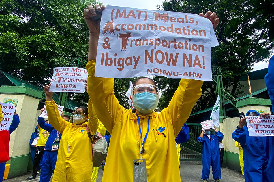 Members of the Alliance of Health Workers hold a noise barrage and ‘die-in’ protest in front of the Department of Health headquarters in Manila on June 22, 2021. The group called for the immediate release of meal, accommodation and transportation allowances of health workers and frontliners in the fight against COVID-19. 