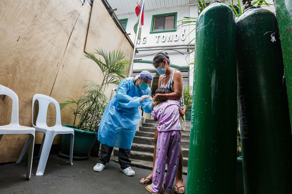 A health worker attends to a non-COVID-19 patient at the triage area of the Ospital ng Tondo on Abad Santos avenue in Manila on August 26, 2021. George Calvelo, ABS-CBN News